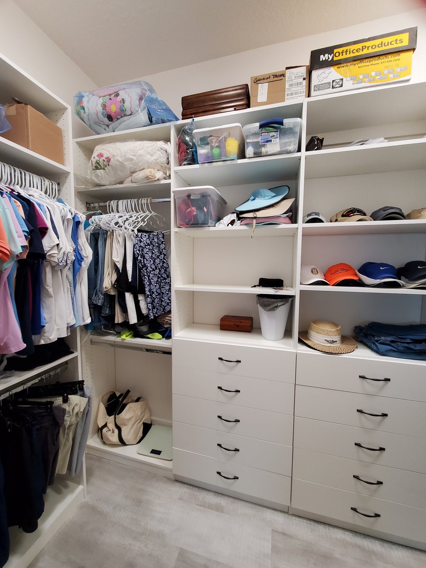 Walk-in closet with hanging clothes and shelving by Create More Space
