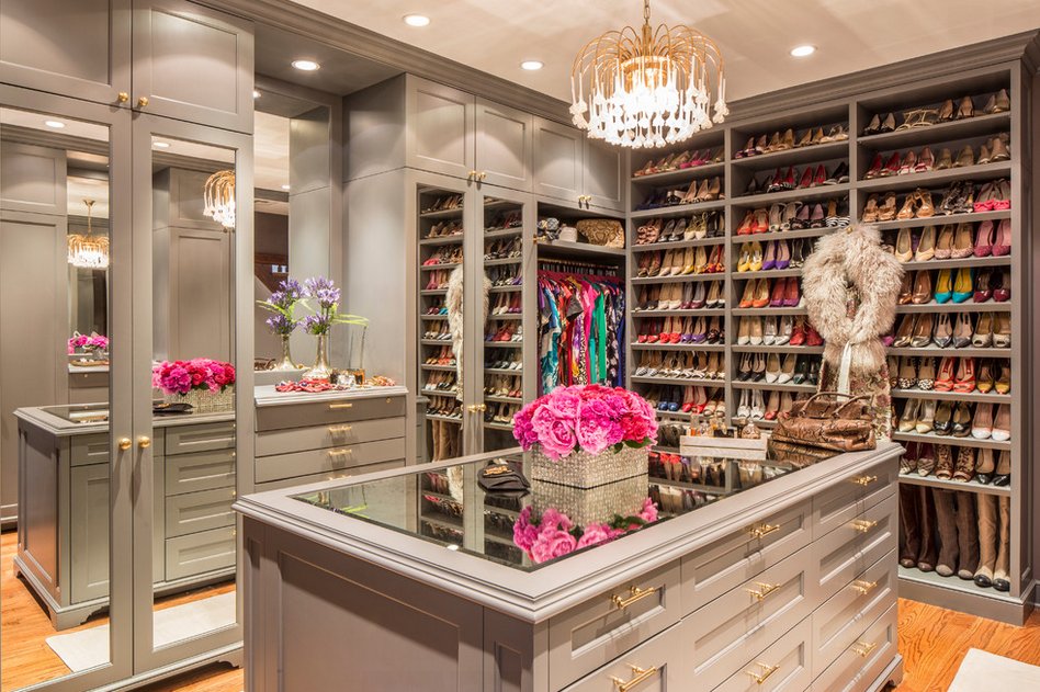 Luxury walk-in closet with chandelier, island and shoe display by Create More Space
