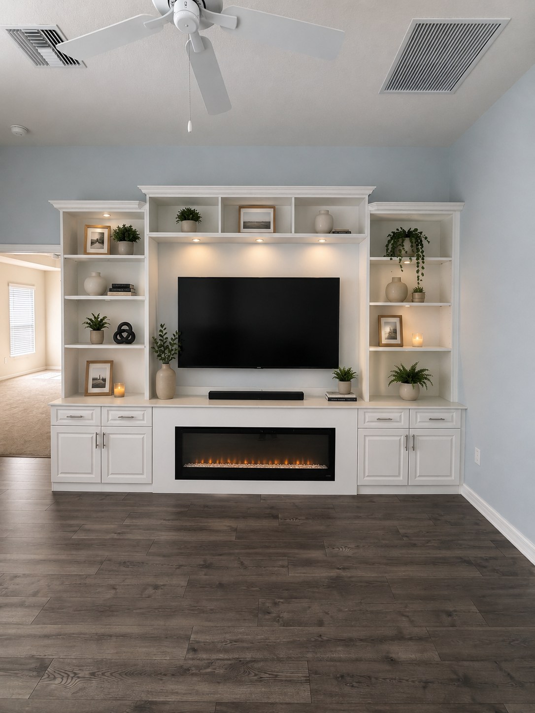 White entertainment center with linear fireplace and TV by Create More Space
