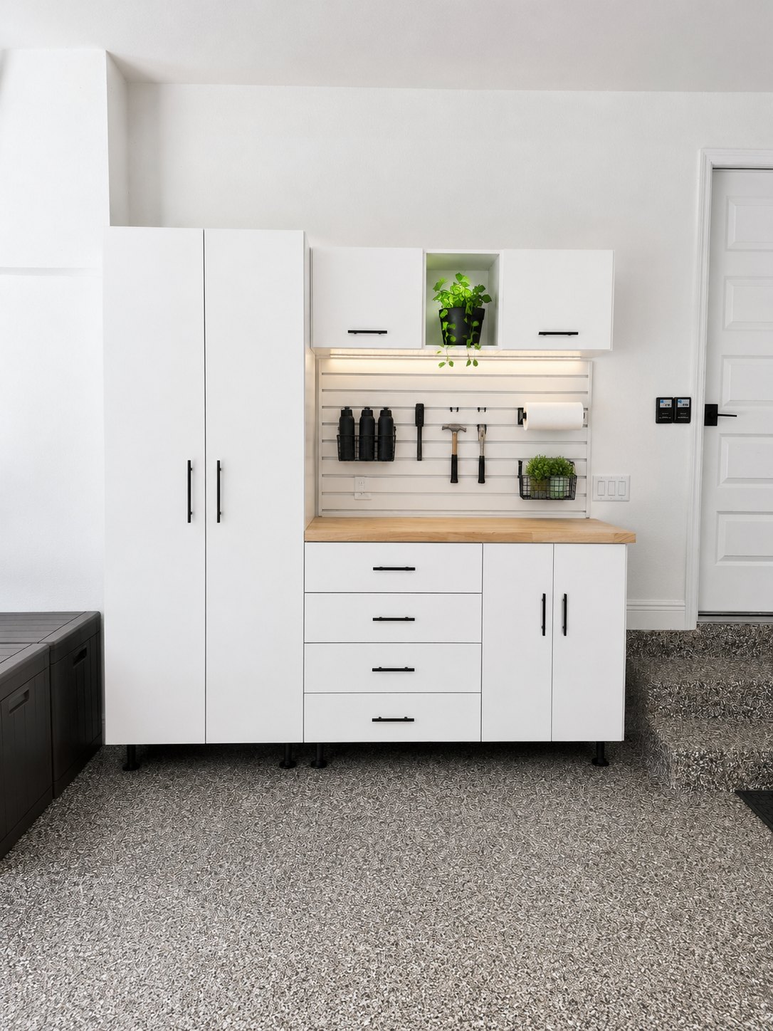 Custom garage cabinets with butcher-block workbench and slat wall