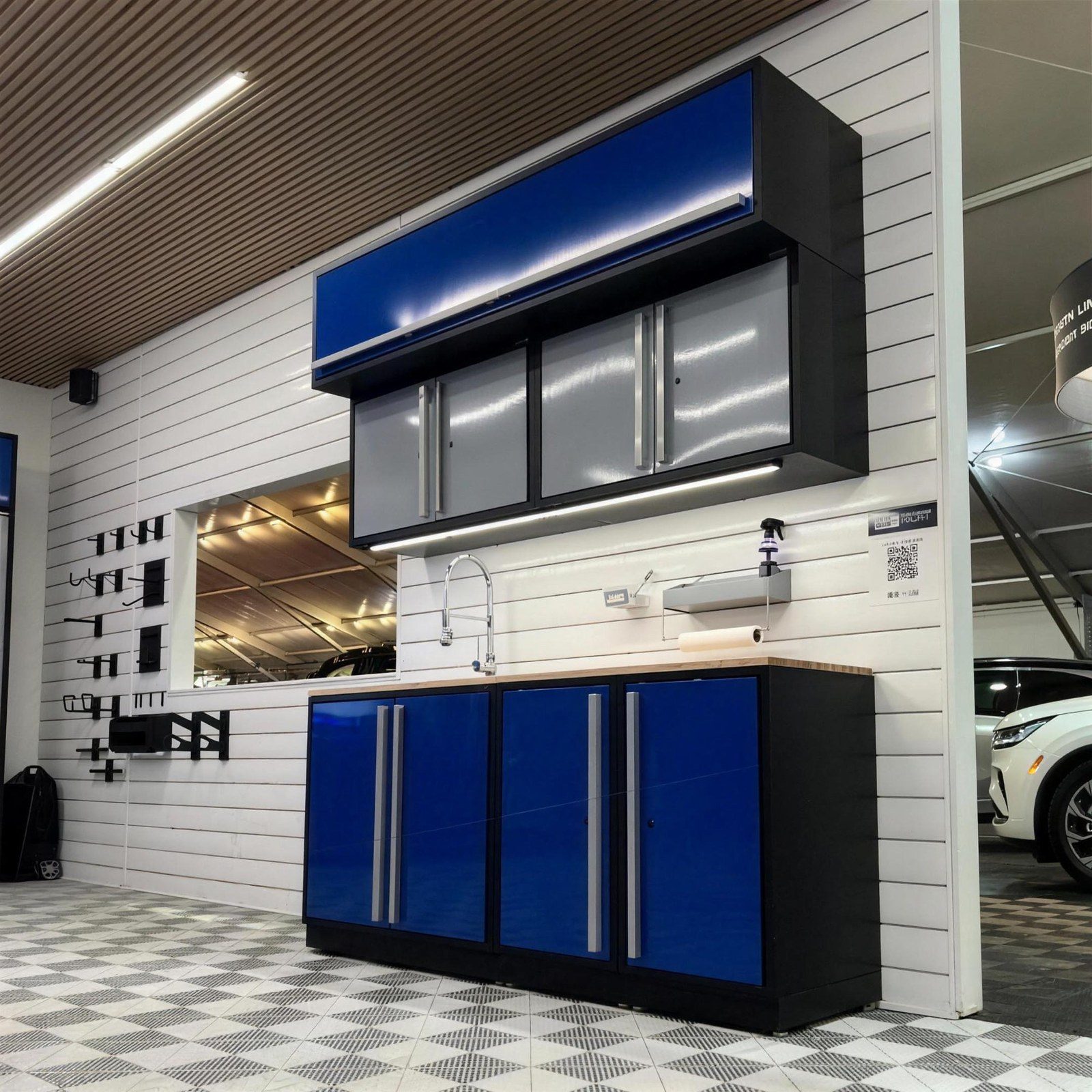 Metal garage cabinetry in blue with slatwall storage by Create More Space