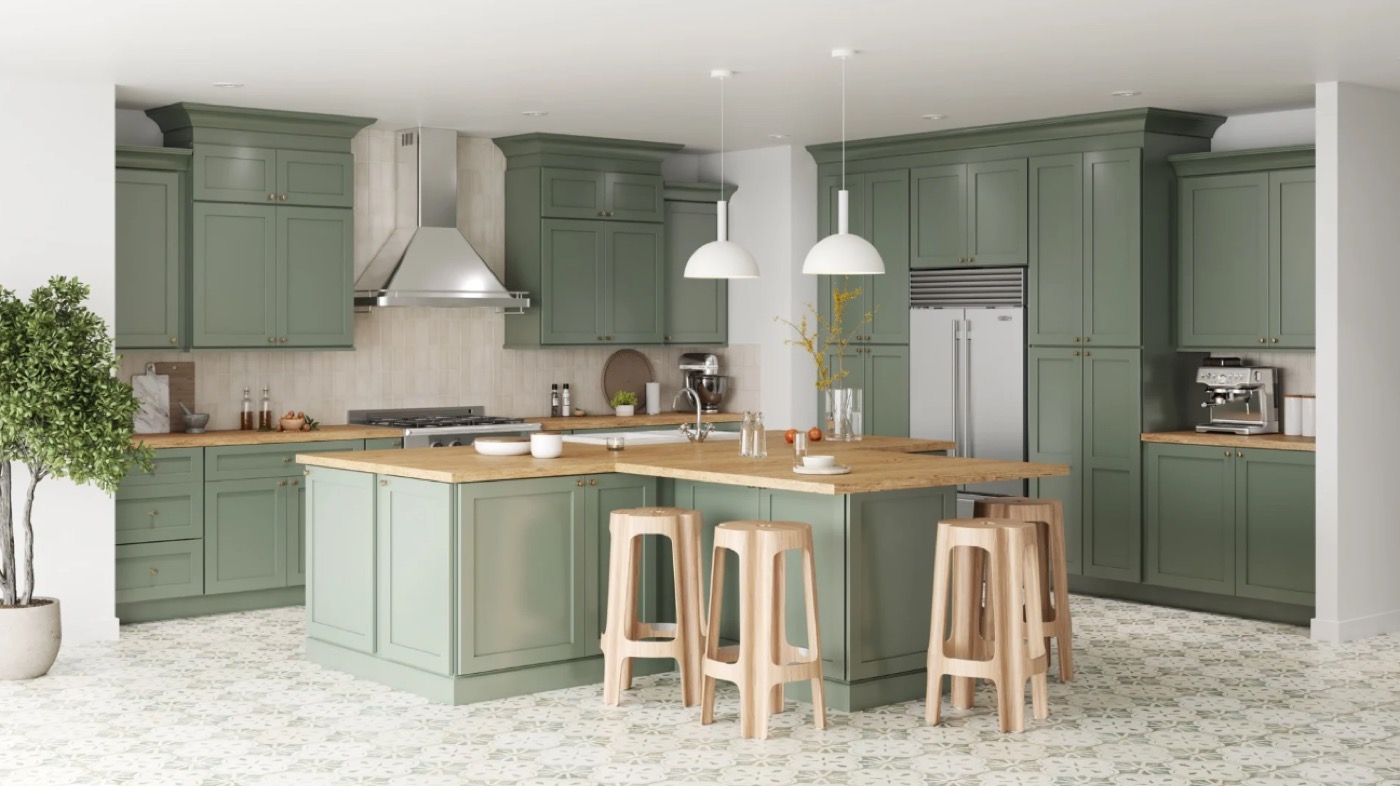 Sage green kitchen with island and bar stools by Create More Space