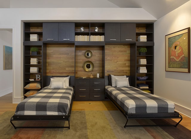Twin built-in wall beds with central cabinetry and display niche