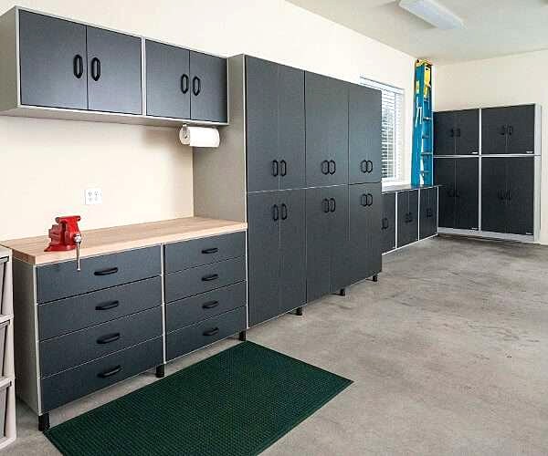 Custom garage with cabinetry, workbench and epoxy floor