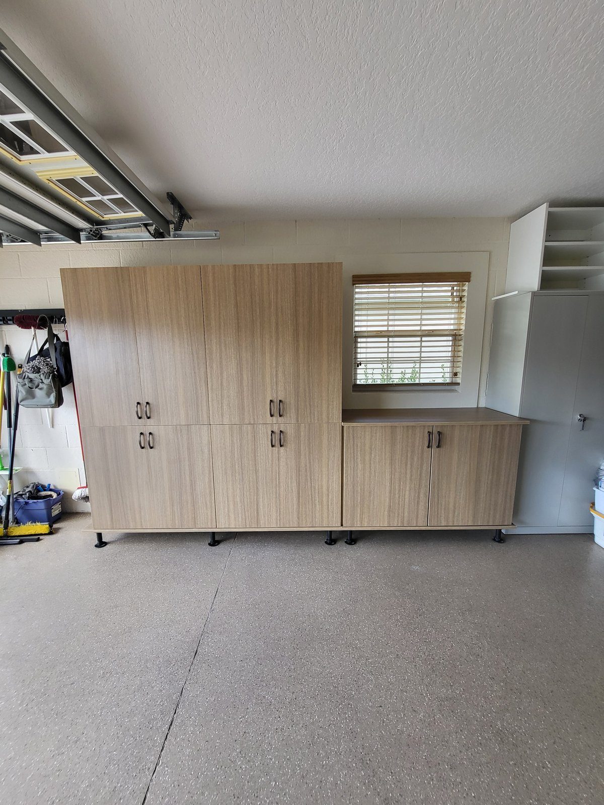 Custom garage storage cabinets in warm finish